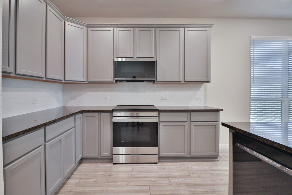 1926 Viva Road Bryan, TX 77807 - Photo 8 of 39 a kitchen with granite countertop white cabinets and stainless steel appliances