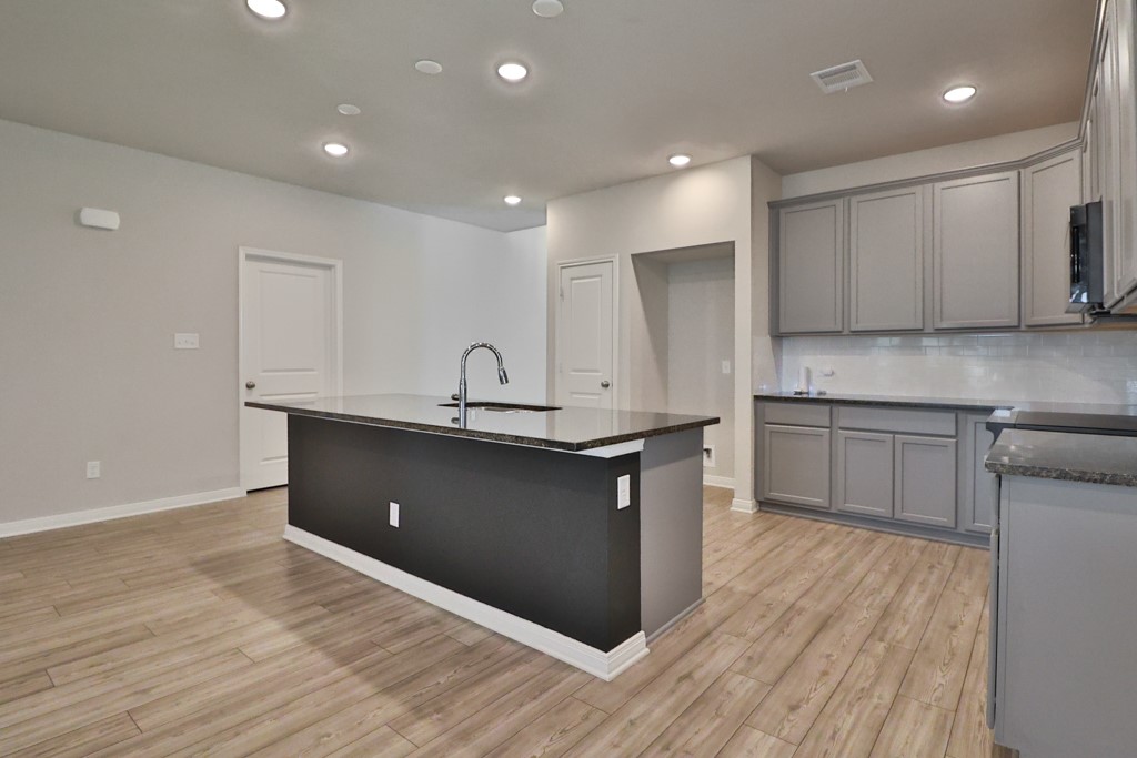 1926 Viva Road Bryan, TX 77807 - Photo 10 of 39 a kitchen with kitchen island granite countertop a sink cabinets and stainless steel appliances