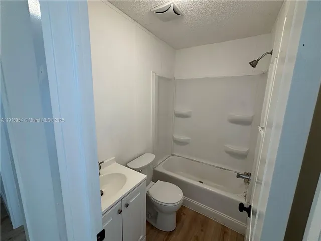 a white toilet sitting next to a shower