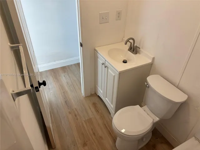a white toilet sitting next to a bathroom sink