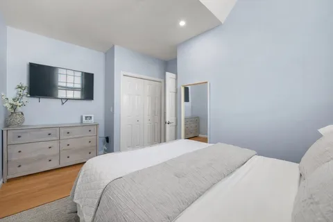 a bedroom with a bed and a flat screen tv