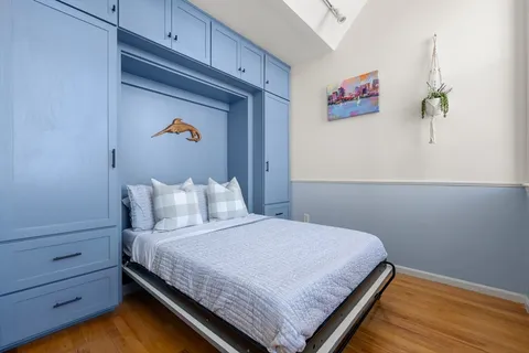 a bedroom with a bed and cabinet