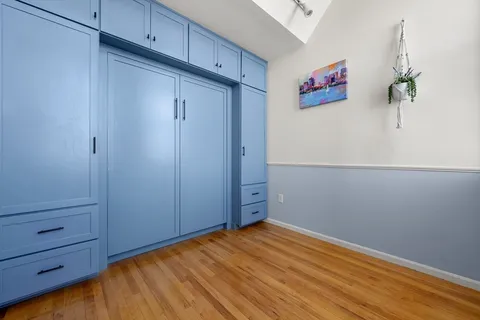 a view of a room with wooden floor