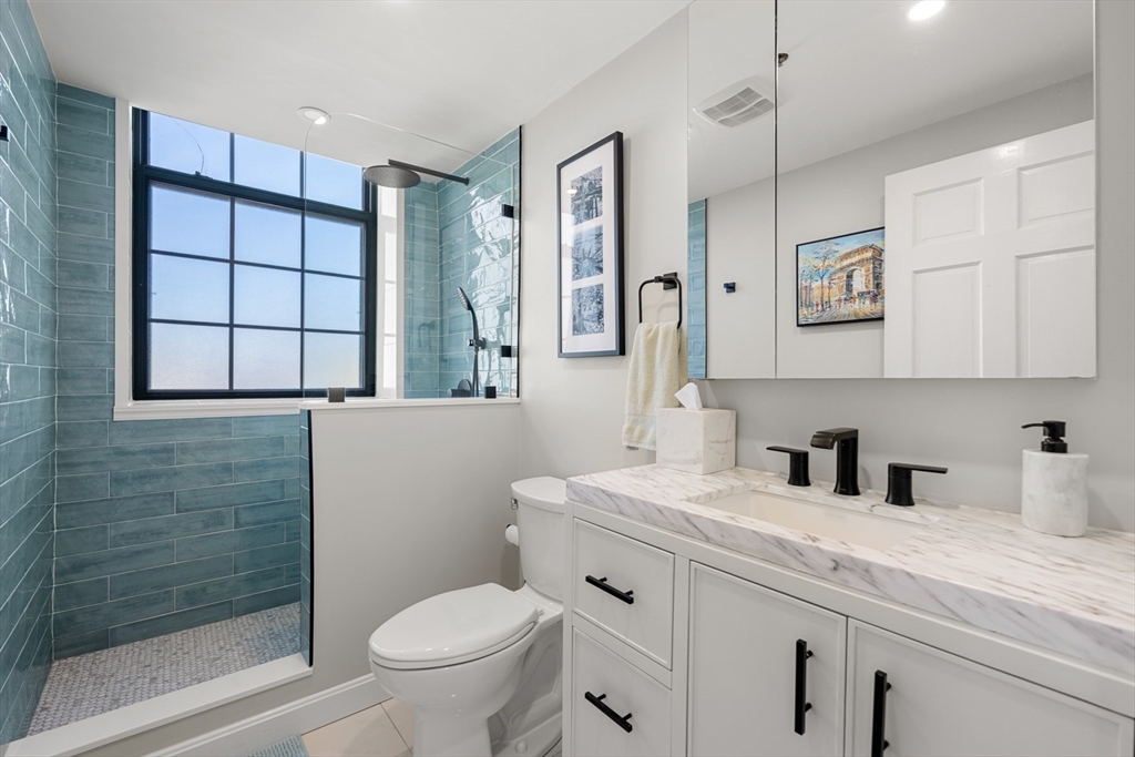 486 East 3rd Street, Unit 6 Boston, MA 02127 - Photo 17 of 20 a bathroom with a sink a toilet and shower