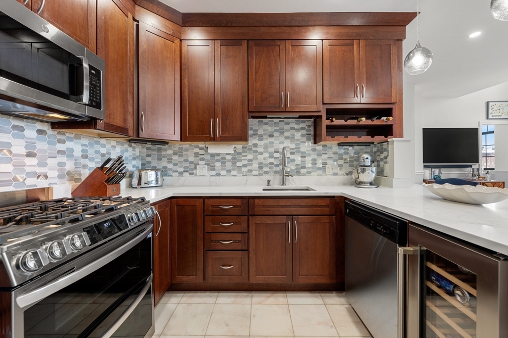 486 East 3rd Street, Unit 6 Boston, MA 02127 - Photo 8 of 20 a kitchen with stainless steel appliances a stove a sink and a microwave