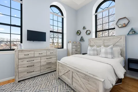 a bedroom with a bed and a flat screen tv