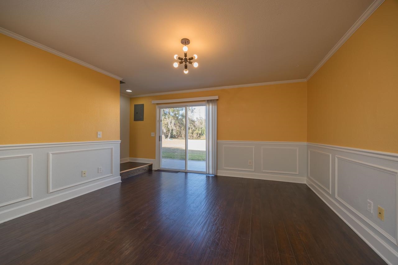 4420 Carter Road, Unit 27 St. Augustine, FL 32086 - Photo 12 of 30 a view of an empty room with a window and wooden floor