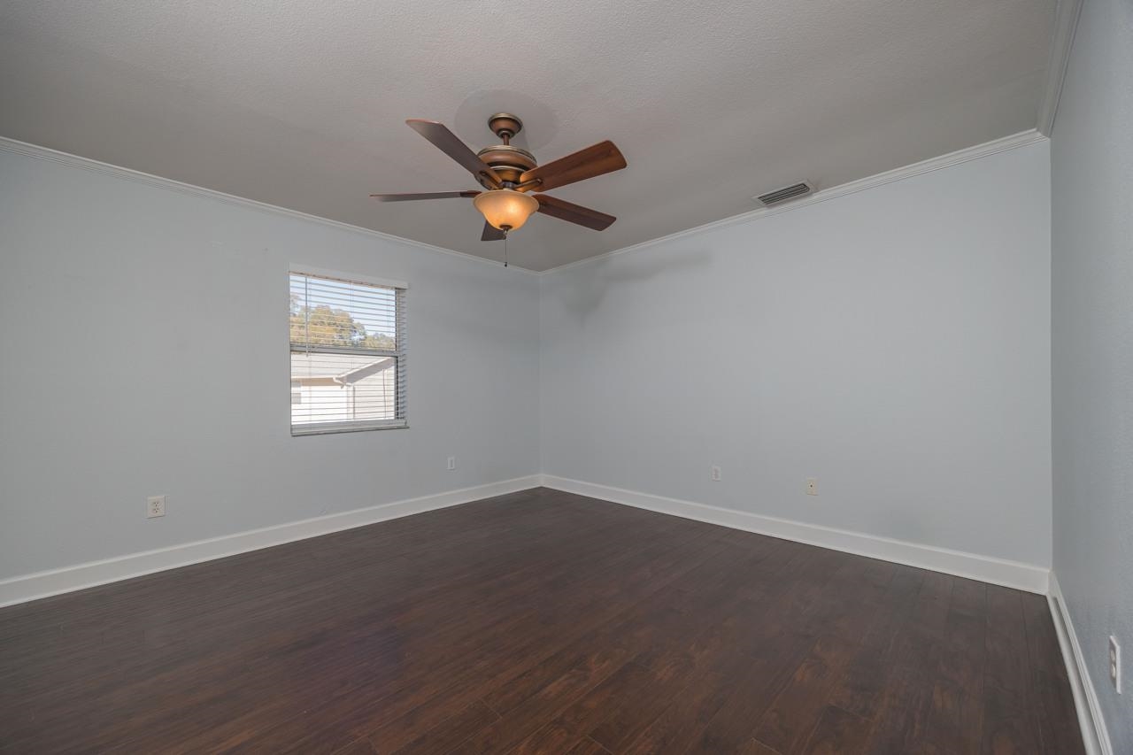 4420 Carter Road, Unit 27 St. Augustine, FL 32086 - Photo 18 of 30 an empty room with a window and a fan