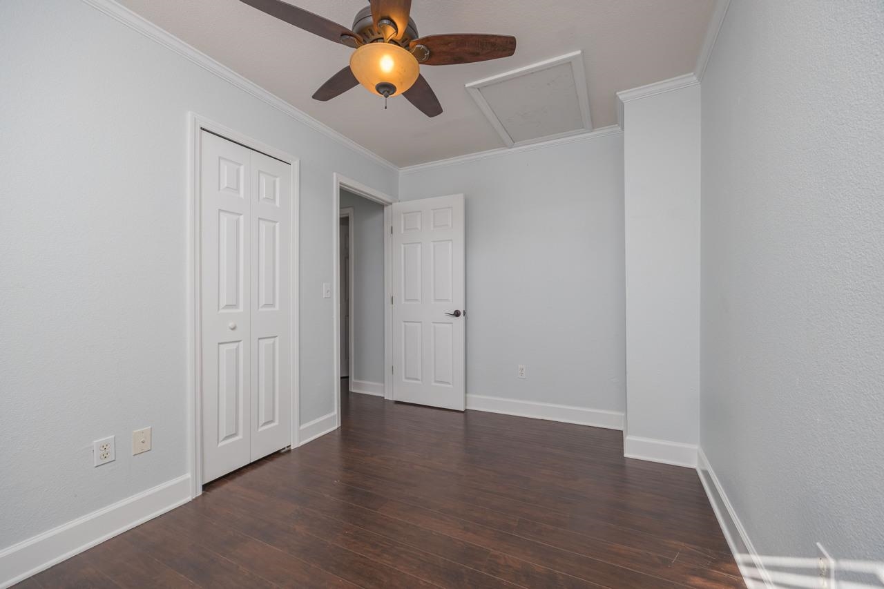 4420 Carter Road, Unit 27 St. Augustine, FL 32086 - Photo 23 of 30 an empty room with wooden floor and windows