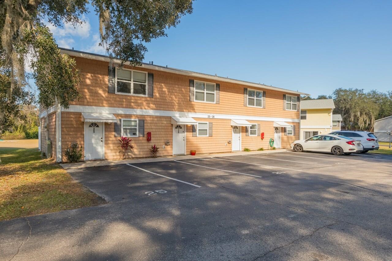 4420 Carter Road, Unit 27 St. Augustine, FL 32086 - Photo 3 of 30 a front view of a building with cars parked on road
