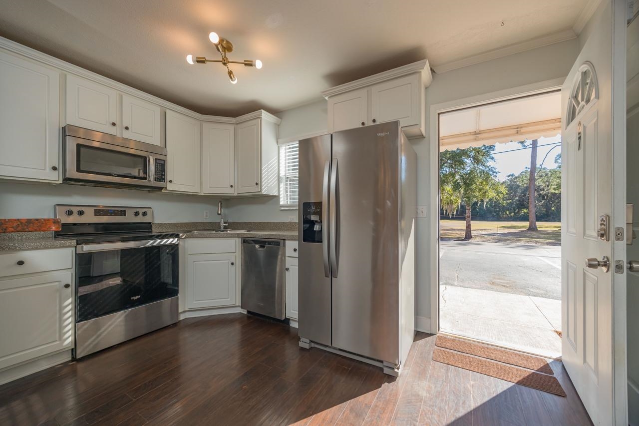 4420 Carter Road, Unit 27 St. Augustine, FL 32086 - Photo 6 of 30 a kitchen with stainless steel appliances a refrigerator sink and microwave