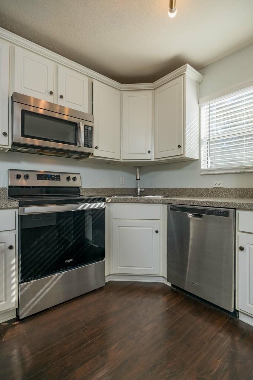 4420 Carter Road, Unit 27 St. Augustine, FL 32086 - Photo 7 of 30 a kitchen with cabinets appliances and wooden floor
