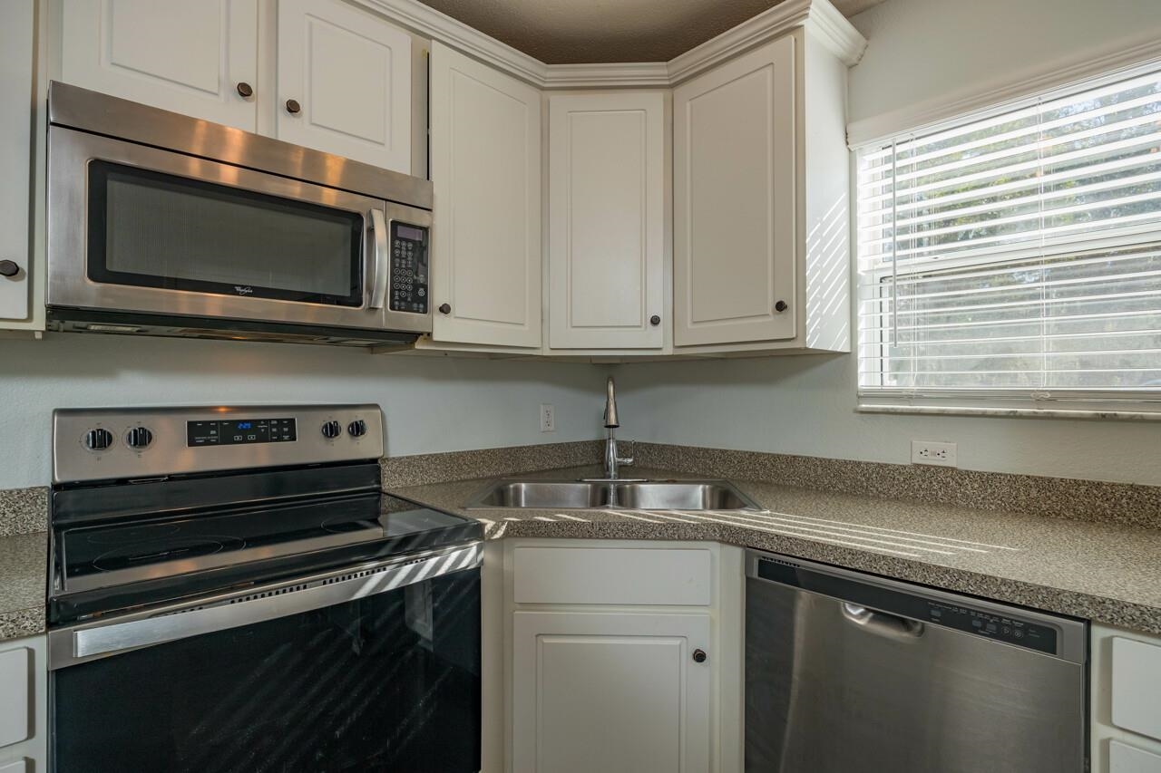 4420 Carter Road, Unit 27 St. Augustine, FL 32086 - Photo 8 of 30 a kitchen with a stove microwave and sink