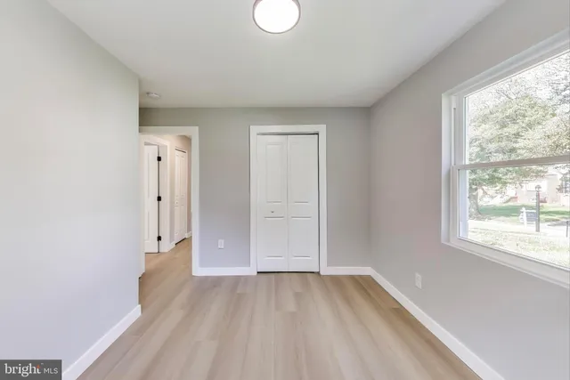 wooden floor in an empty room with a window