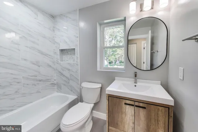 a bathroom with a sink a toilet and a mirror