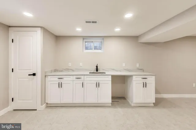 a spacious bathroom with a sink double vanity and a mirror