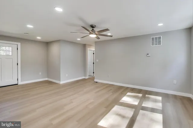 wooden floor in an empty room with a window