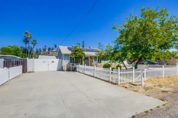 a view of a house with a backyard and a garage