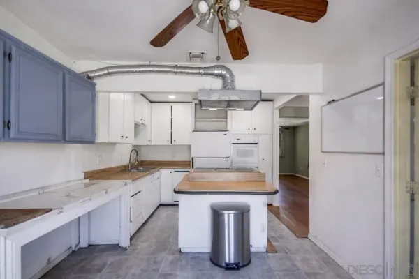 a kitchen with a sink cabinets and window