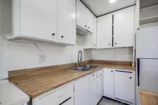 a white refrigerator freezer sitting inside of a kitchen