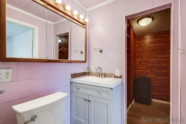 a bathroom with a shower a toilet and a sink