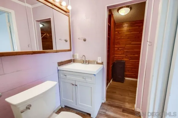 a view of a room with wooden floor