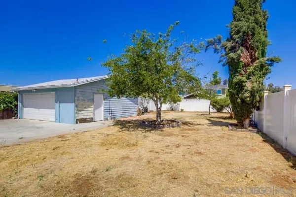 a view of a house with wooden fence