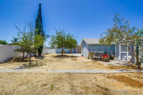 a view of a house with a yard and garage