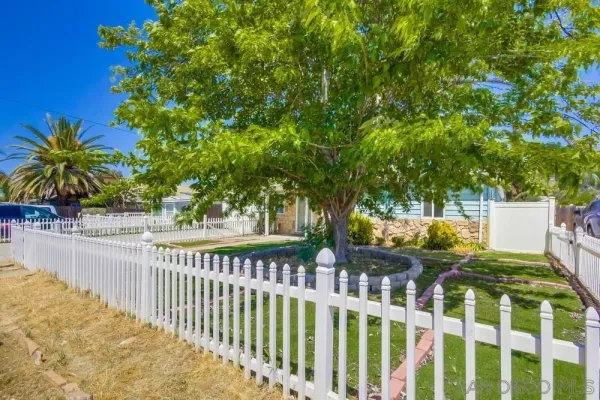 a view of a house with wooden fence