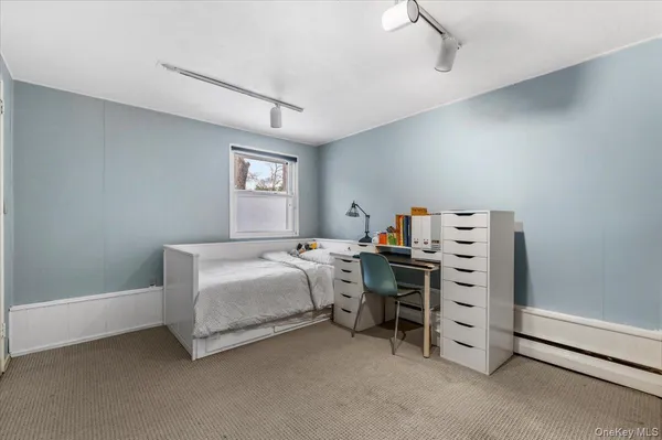 a bedroom with bed and a window