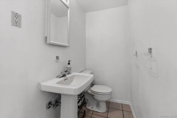a bathroom with a sink a toilet and mirror