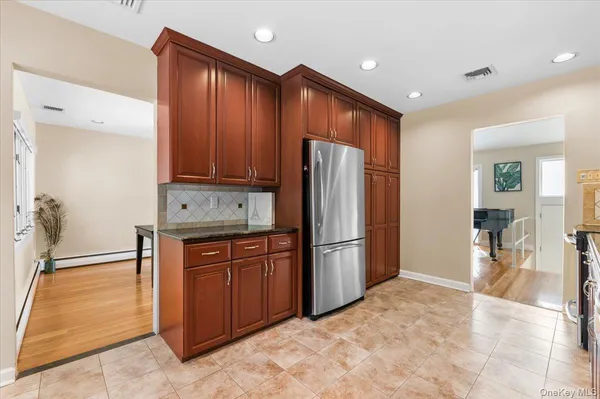 a view of kitchen with refrigerator cabinets and wooden floor