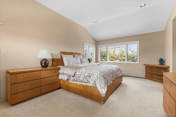 a spacious bedroom with a bed and a window