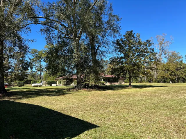 a view of a swimming pool with an outdoor seating and a yard