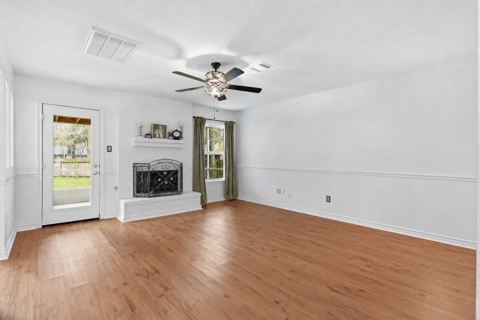 10 East Broken Oak Court Spring, TX 77381 - Photo 11 of 31 Spacious living room with brick fireplace and stained glass ceiling fan.