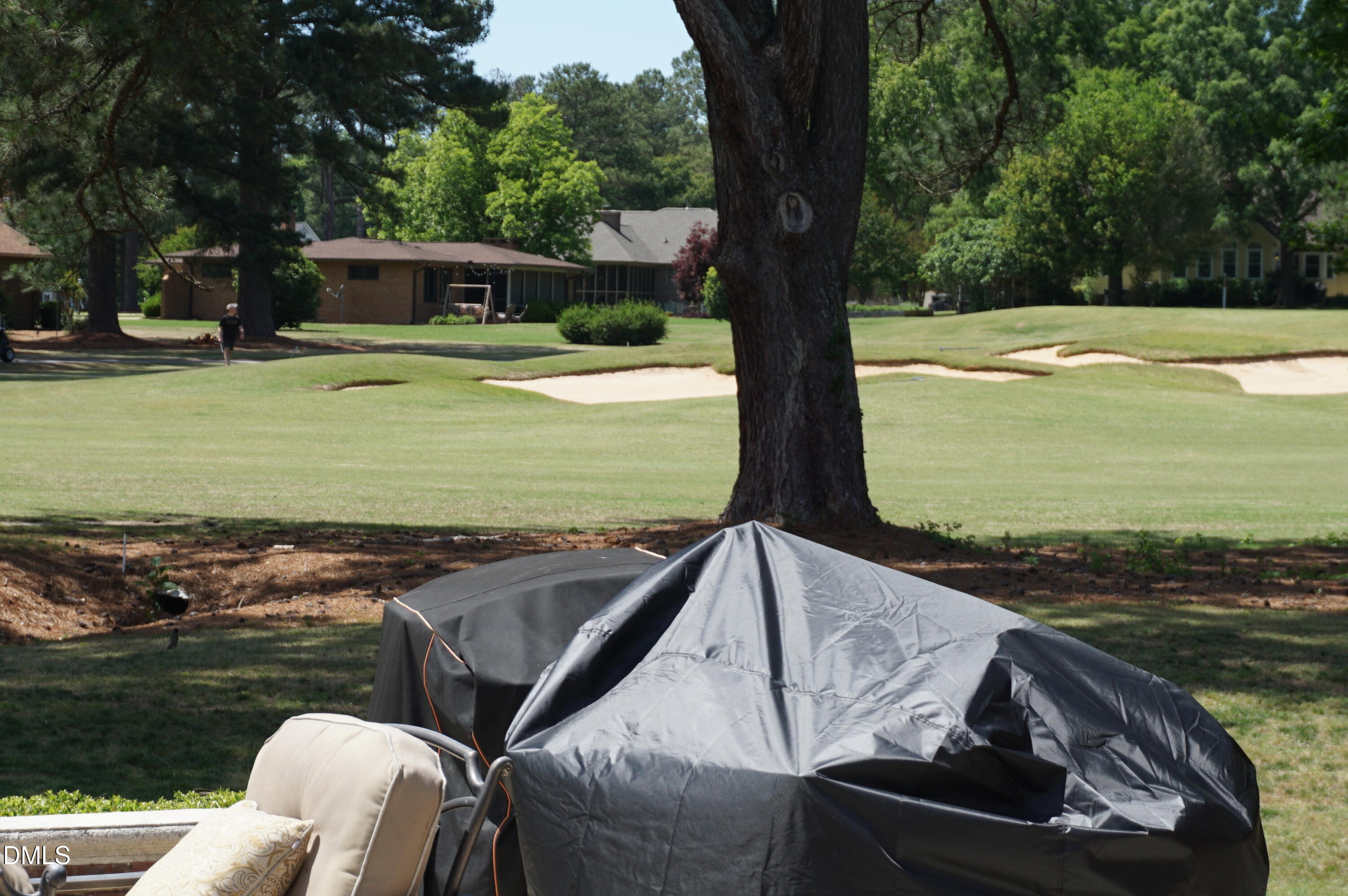 2125 Keith Hills Road Lillington, NC 27546 - Photo 63 of 66 a view of a backyard with lawn chairs under an umbrella
