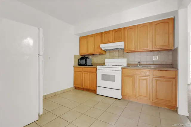 a kitchen with a stove top oven sink and cabinets