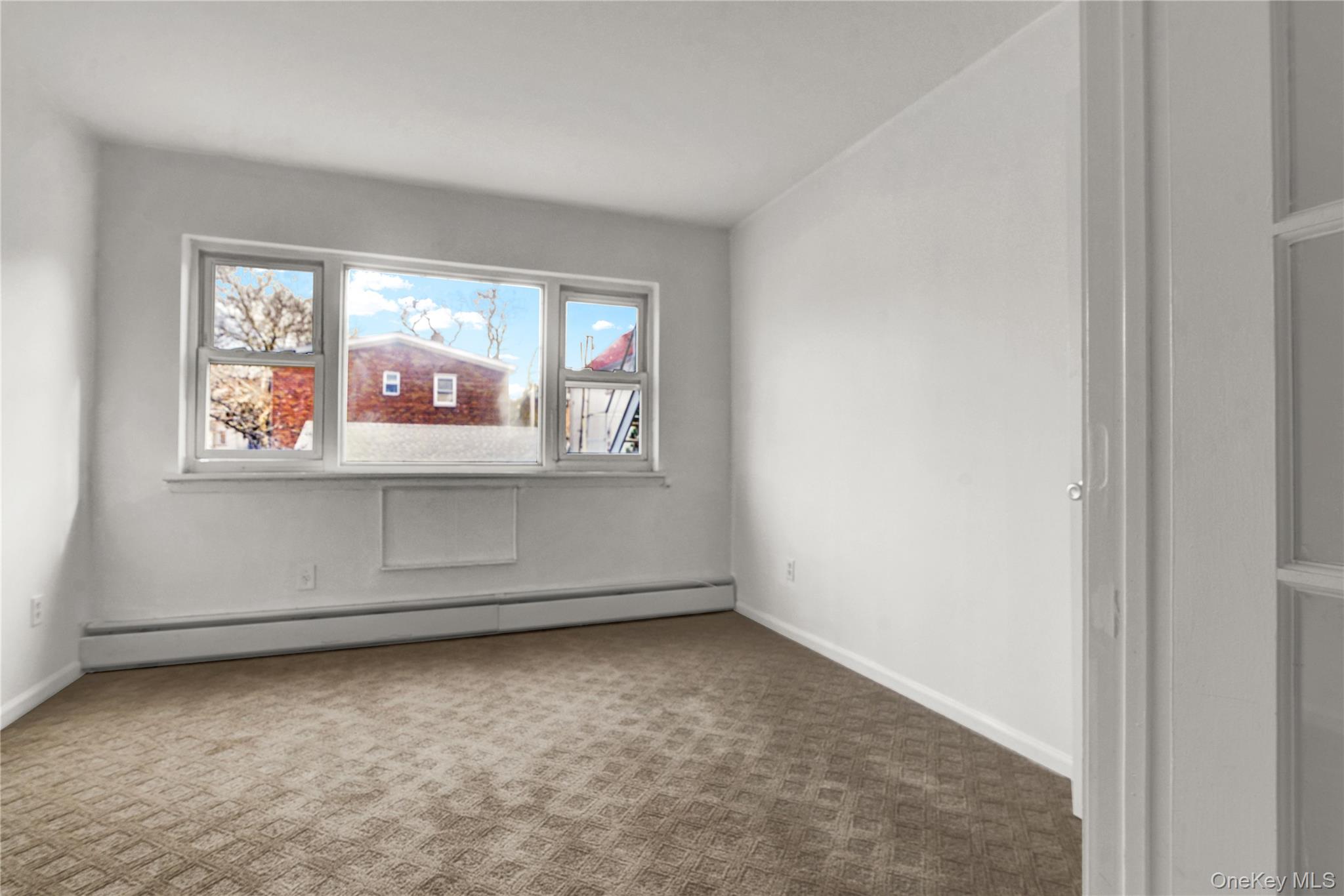 20-39 49th Street Queens, NY 11105 - Photo 15 of 26 an empty room with windows