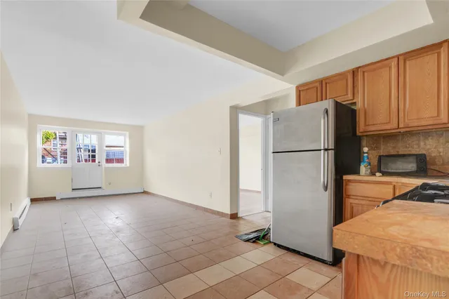 a refrigerator freezer sitting in a kitchen with stainless steel appliances granite countertop a refrigerator and a sink