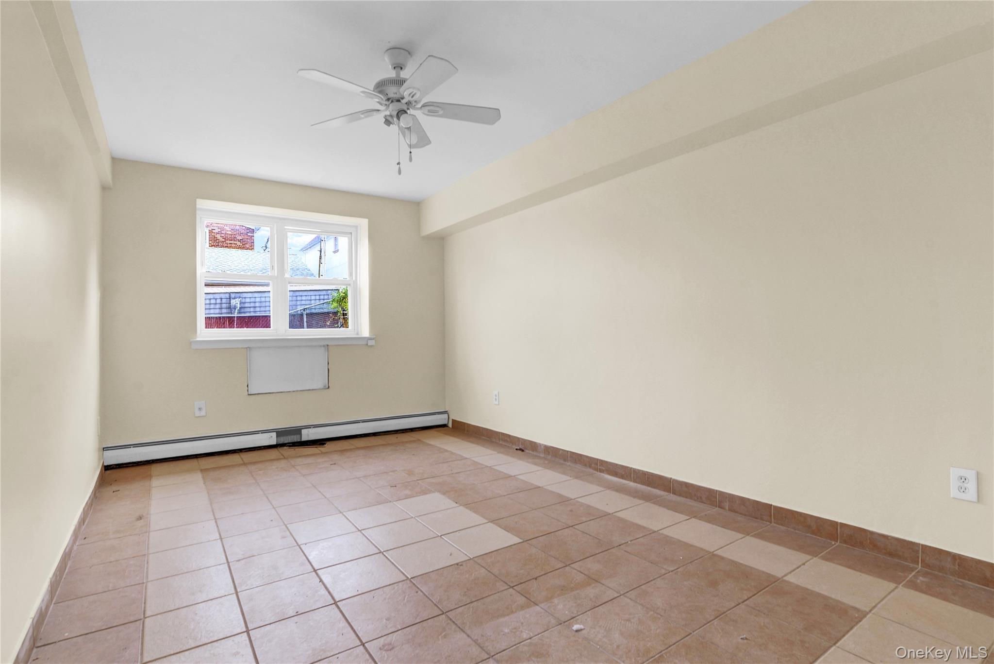 20-39 49th Street Queens, NY 11105 - Photo 23 of 26 an empty room with windows and fan