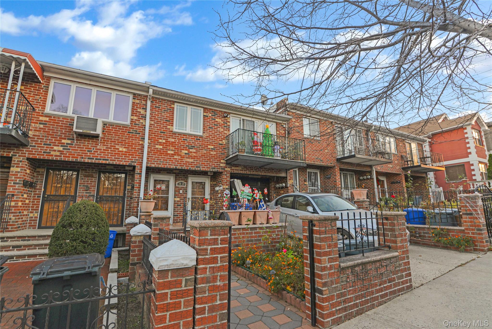 20-39 49th Street Queens, NY 11105 - Photo 26 of 26 a front view of a brick house with large windows