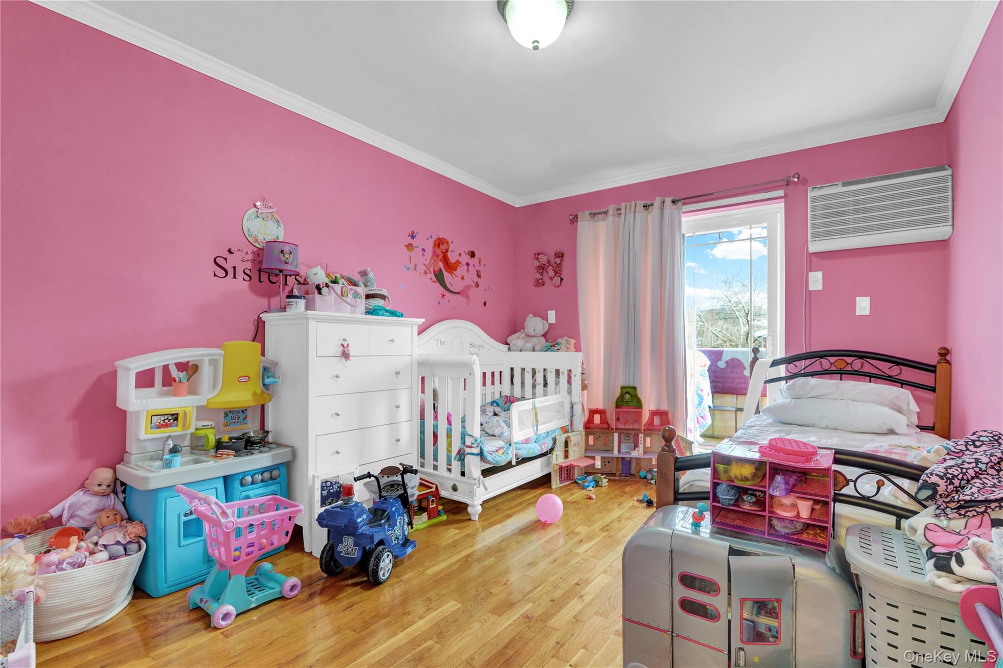 20-39 49th Street Queens, NY 11105 - Photo 9 of 26 a bedroom with furniture and a baby crib