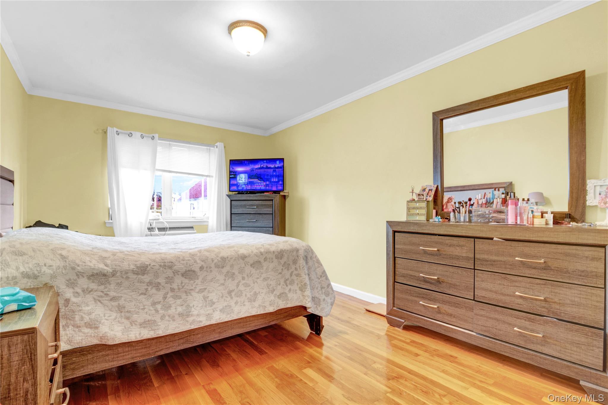 20-39 49th Street Queens, NY 11105 - Photo 10 of 26 a bedroom with a bed and a dresser