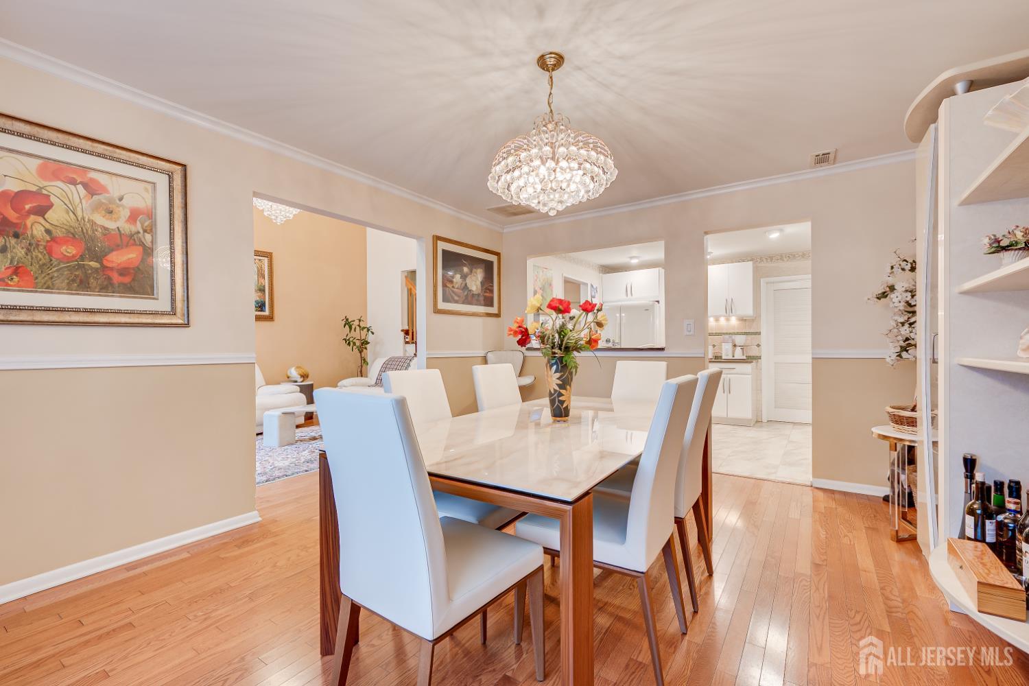 114 Coppertree Court Edison, NJ 08820 - Photo 19 of 47 a view of a dining room with furniture wooden floor and a chandelier