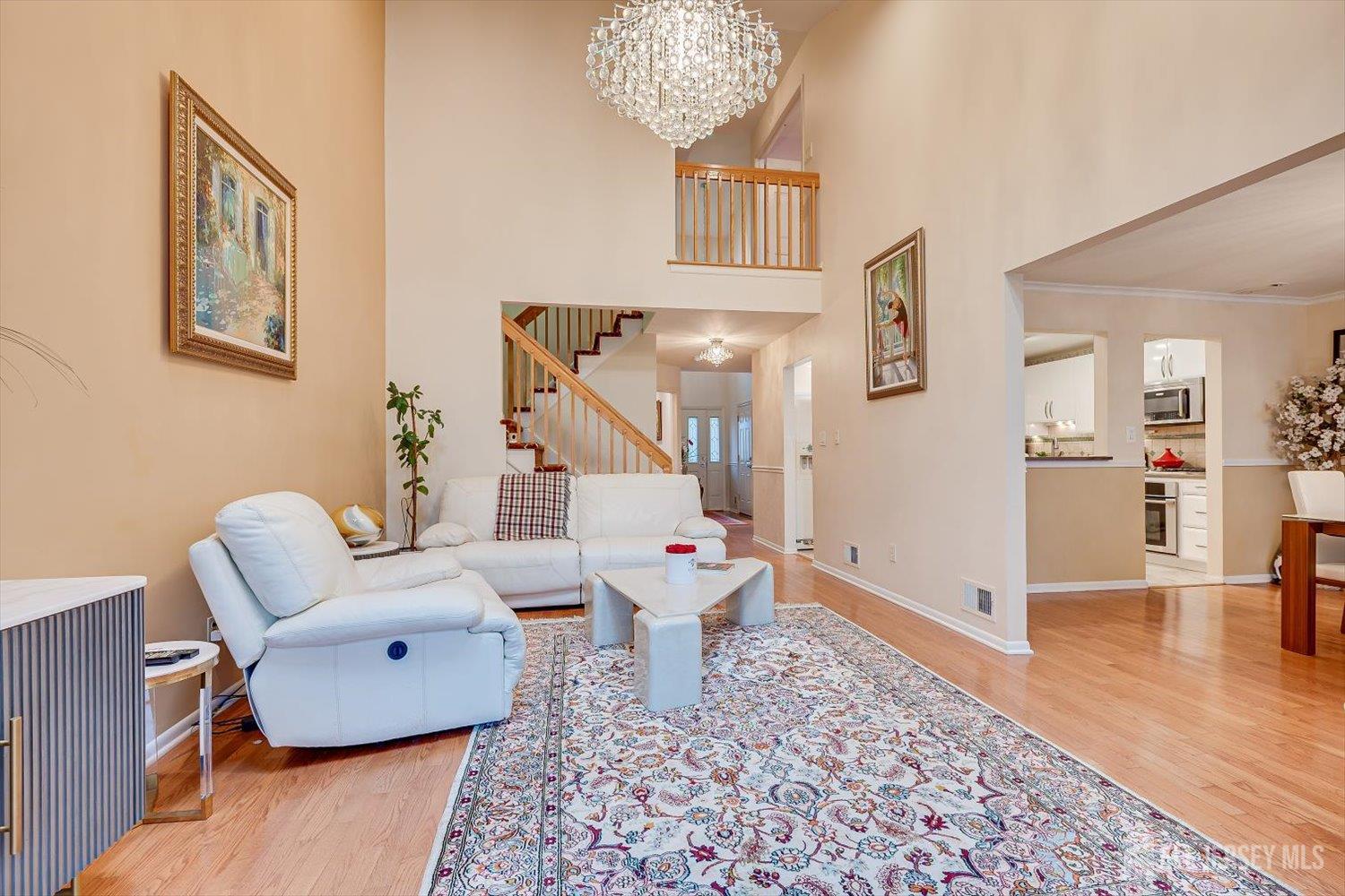 114 Coppertree Court Edison, NJ 08820 - Photo 7 of 47 a living room with furniture and a chandelier