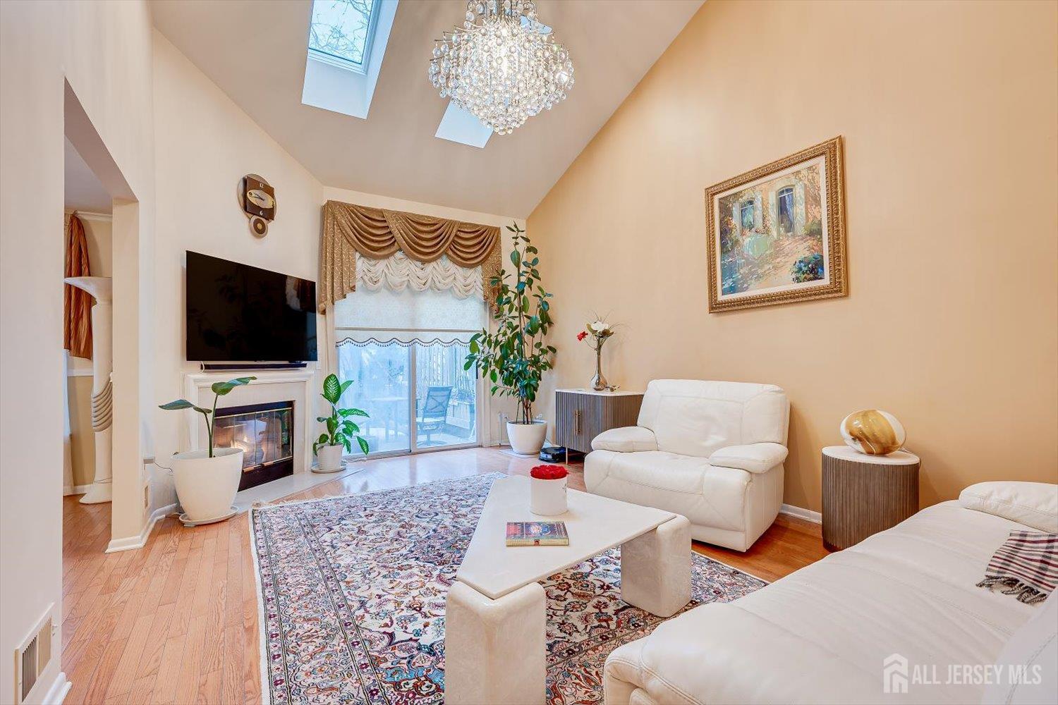 114 Coppertree Court Edison, NJ 08820 - Photo 10 of 47 a living room with couches a flat screen tv and a fireplace