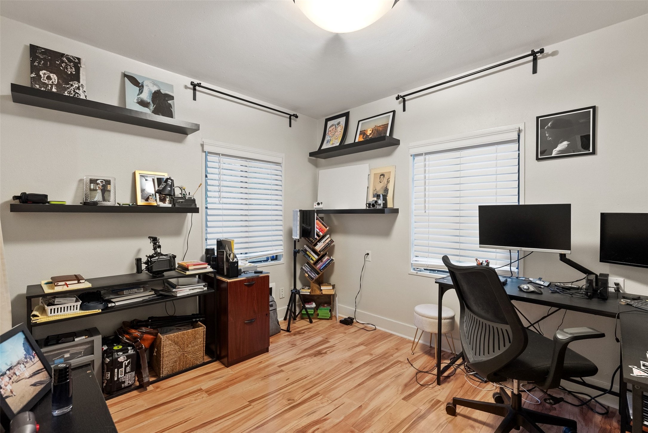 412 West Croslin Street Austin, TX 78752 - Photo 11 of 36 Well-lit office space with natural wood-tone flooring and multiple windows, perfect for productivity.