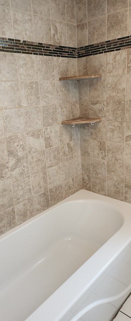 Undisclosed Address Midlothian, IL 60445 - Photo 16 of 23 a bathroom with a bathtub and a shower