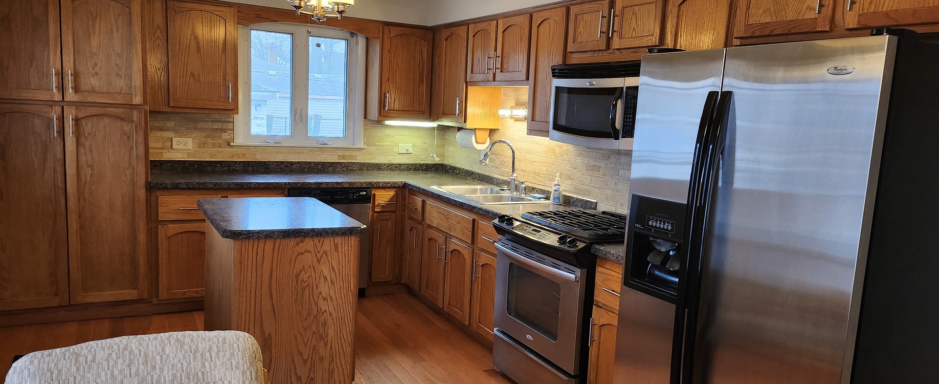 Undisclosed Address Midlothian, IL 60445 - Photo 5 of 23 a kitchen with stainless steel appliances granite countertop a sink stove and refrigerator