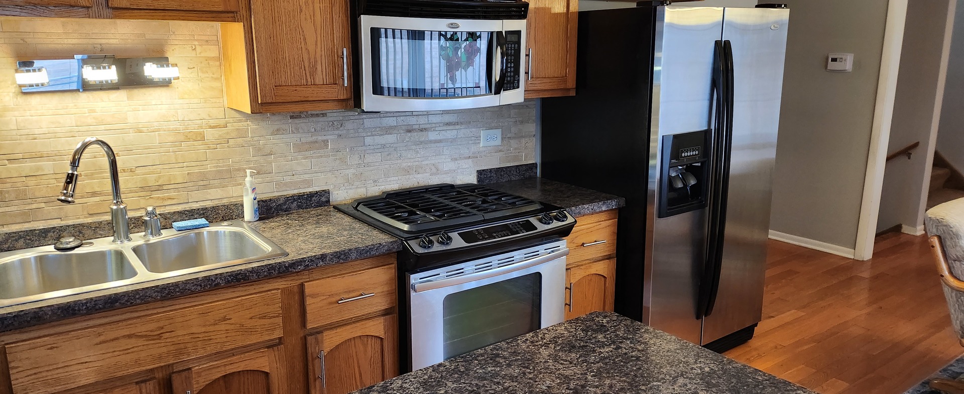 Undisclosed Address Midlothian, IL 60445 - Photo 6 of 23 a kitchen with granite countertop a sink stainless steel appliances and cabinets